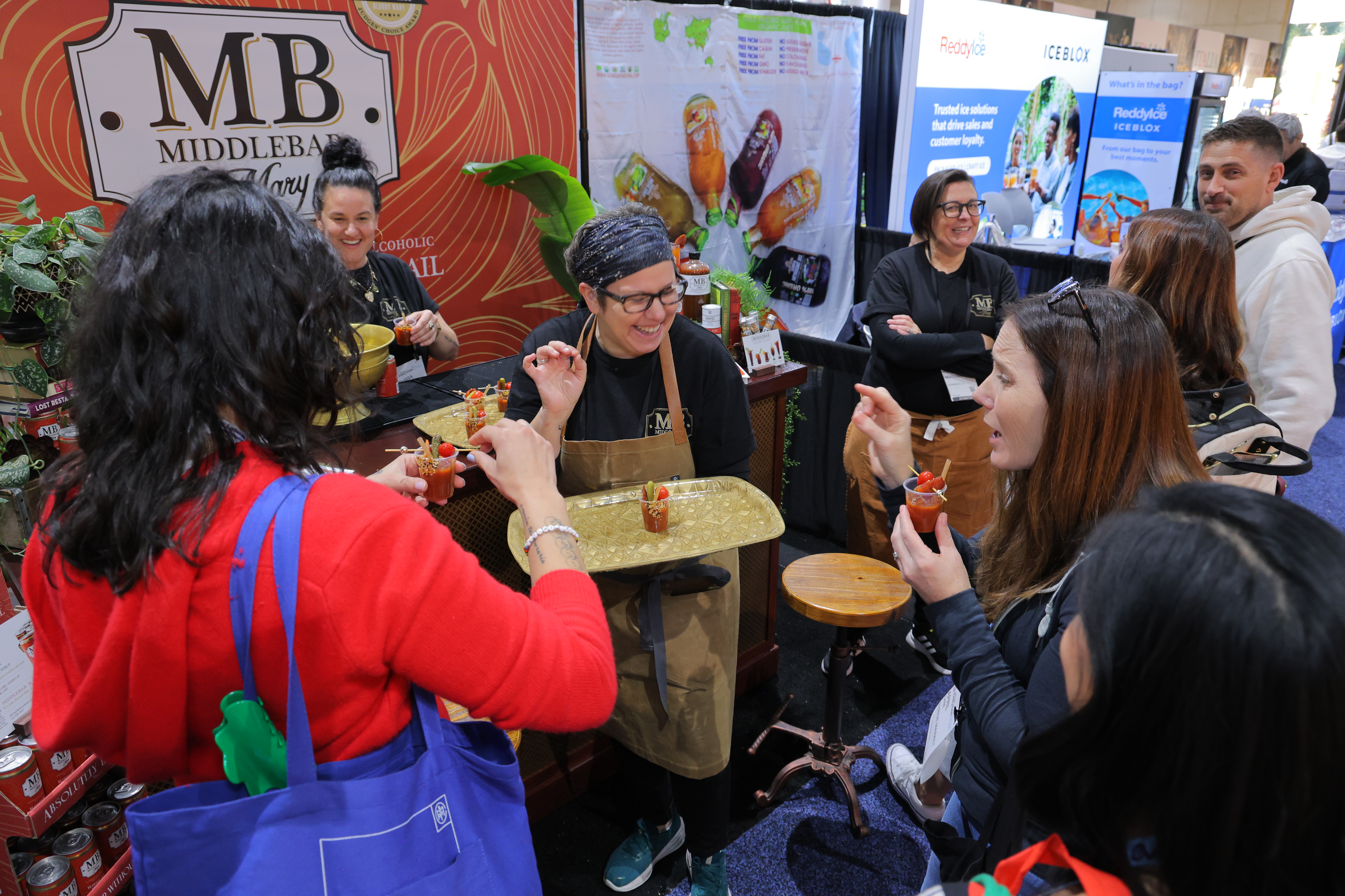 Attendees sampling at a booth