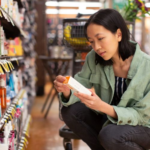 woman inspects food package at store