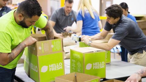 People packing Hello Fresh boxes
