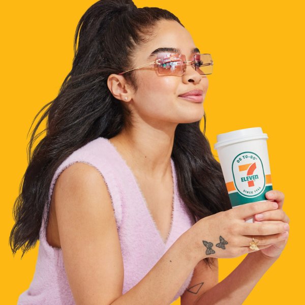Woman holding 7-Eleven cup