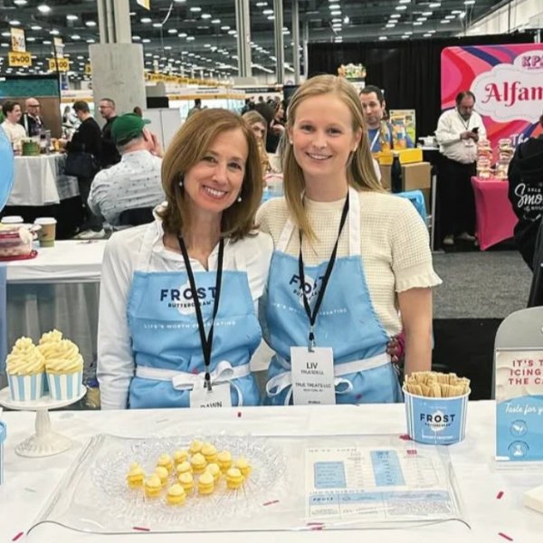 FROST Buttercream founders standing at an exhibit table