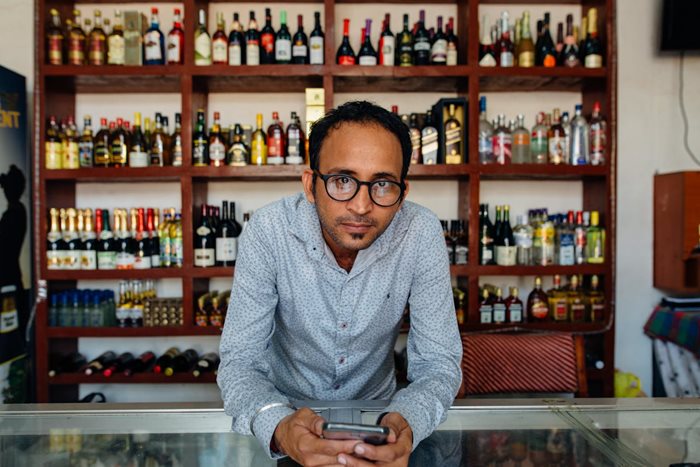 Man behind counter at liquor store