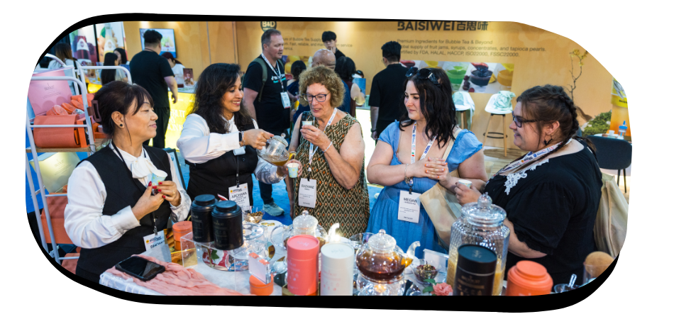 Attendees and an exhibitor smiling