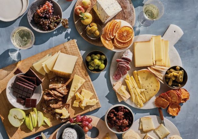 Charcuterie board with many cheeses