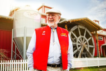 Bob's Red Mill Founder in front of mill.